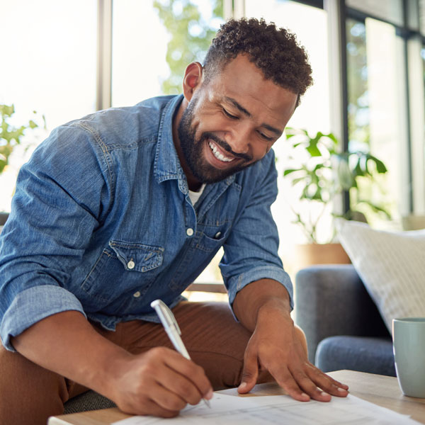 man writing on paper