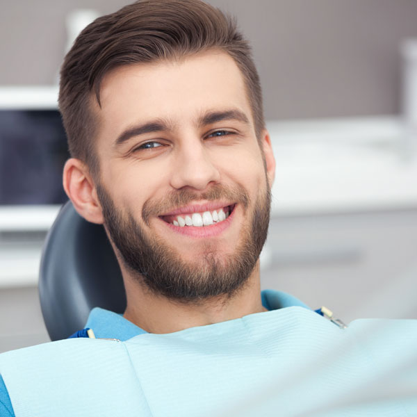 man in dental chair smiling