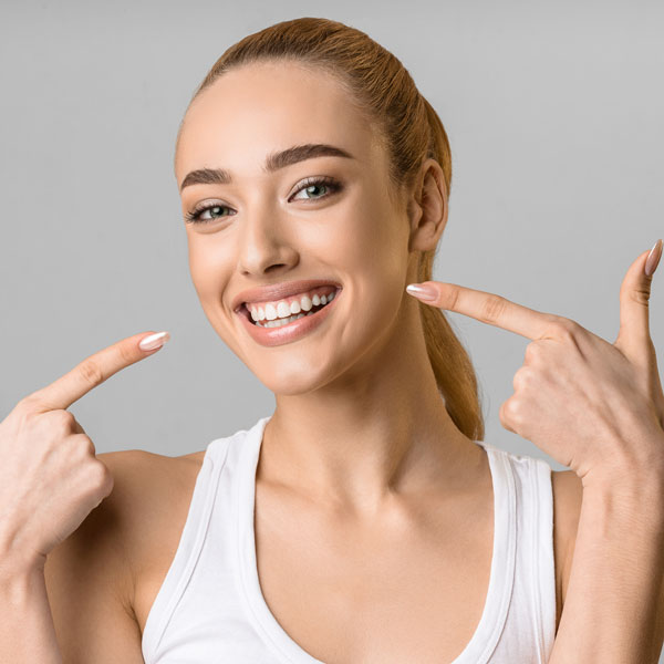 woman pointing at her smile