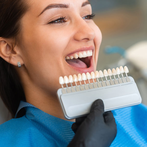 woman looking at teeth whitening