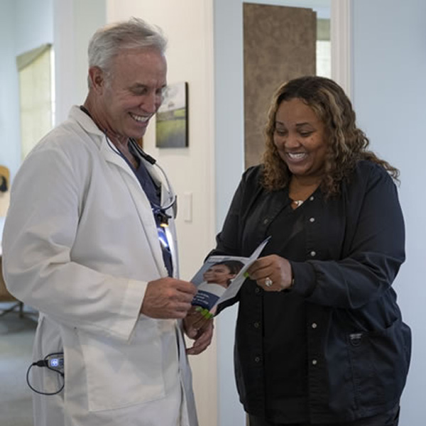 Dr. Beal reviewing brochure with staff member